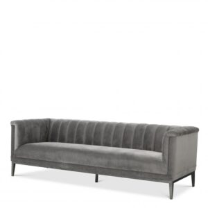 The Mid-Century Modern Raffles Sofa rests upon a powder-coated steel base with gunmetal finish and is beautifully upholstered in Porpoise grey velvet.